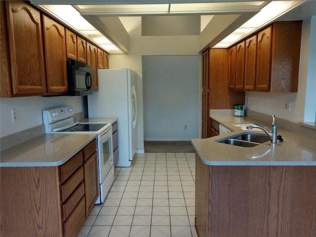 kitchen featuring black microwave, light countertops, light tile patterned floors, white electric stove, and a sink