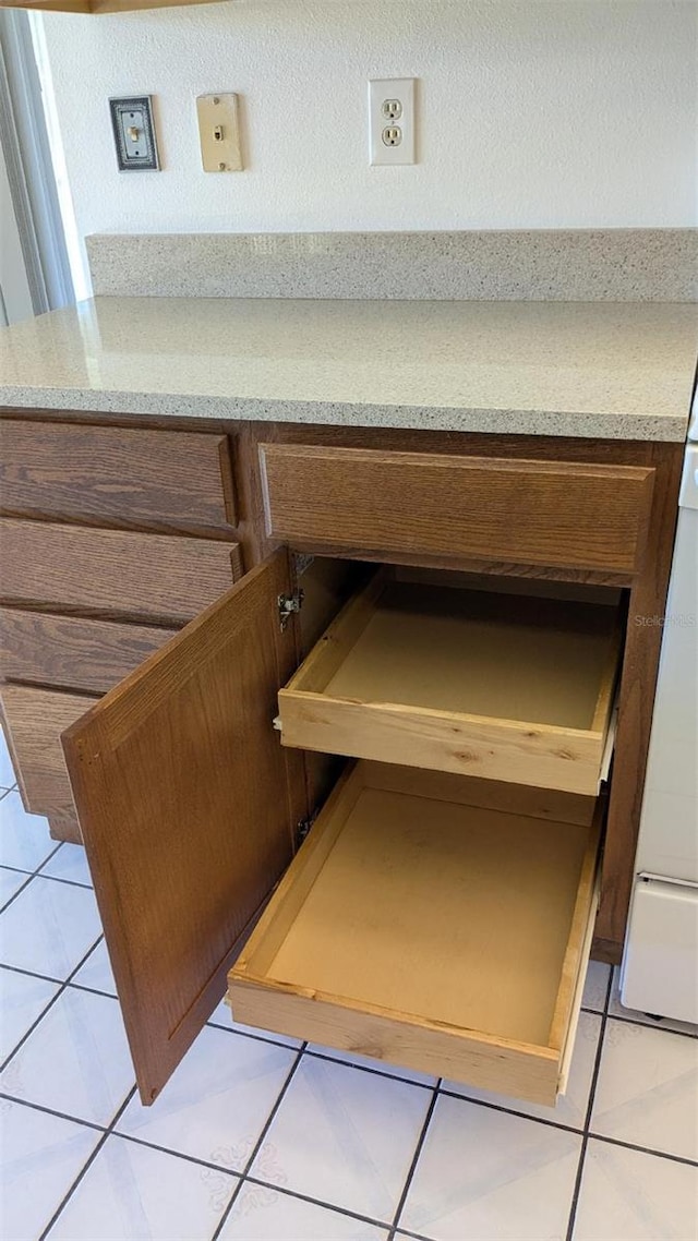 interior details featuring brown cabinetry and light countertops