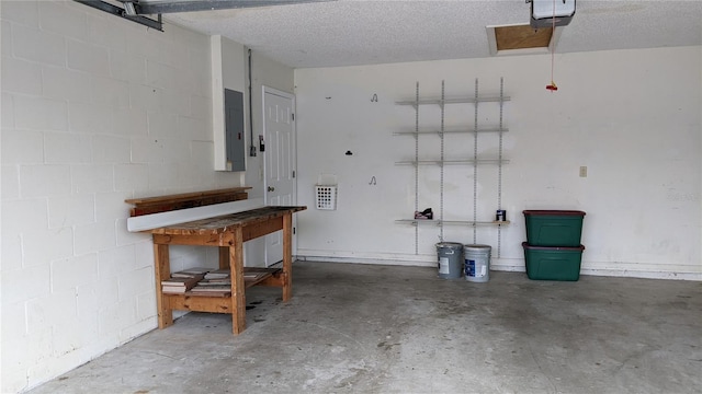 garage with electric panel, concrete block wall, and a garage door opener