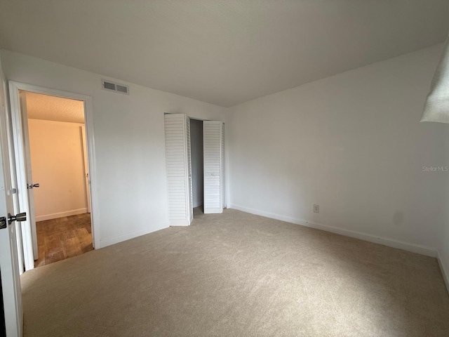 7529 Pitch Pine Cir Unit 190, Tampa, FL 33617 - unfurnished bedroom with carpet, visible vents, a closet, and baseboards