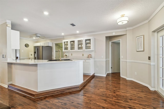 kitchen featuring visible vents, a sink, light countertops, white cabinetry, and high end refrigerator