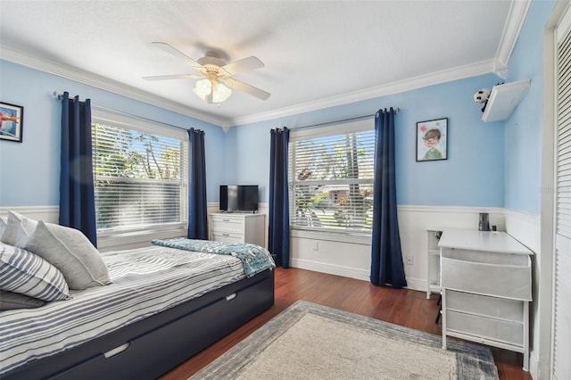 bedroom with crown molding, multiple windows, wood finished floors, and a ceiling fan