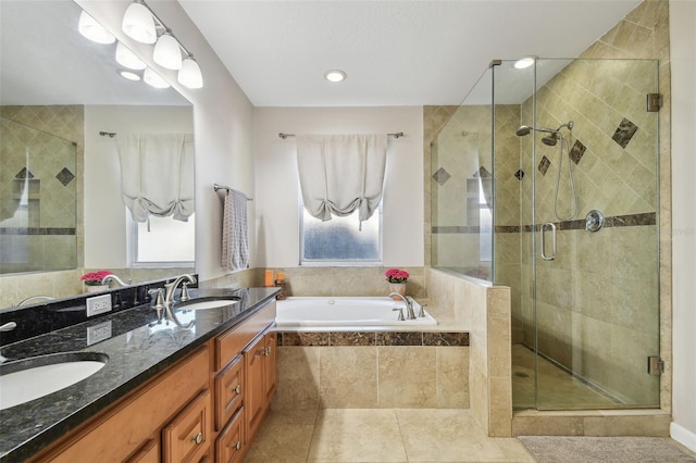 bathroom with a sink, tile patterned floors, a bath, and a shower stall