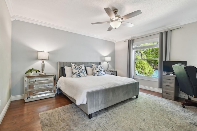 bedroom featuring baseboards, ornamental molding, a textured ceiling, a ceiling fan, and wood finished floors