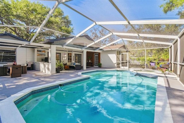 pool with a lanai, a patio area, and an outdoor hangout area