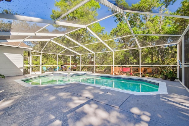 view of pool featuring a lanai, a patio, and a pool with connected hot tub