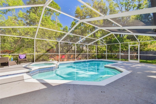 view of pool featuring a patio, a pool with connected hot tub, a fenced backyard, and a lanai