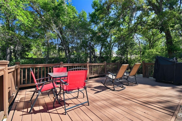 deck featuring grilling area and outdoor dining area