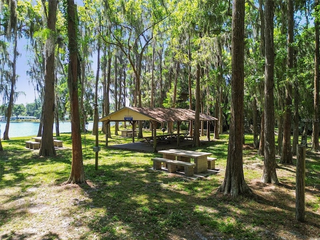 view of property's community featuring a yard, a gazebo, and a water view