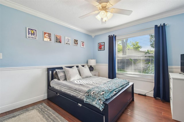 bedroom featuring crown molding, wood finished floors, and baseboards