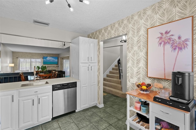 6140 Sun Blvd Unit 7, Saint Petersburg, FL 33715 - kitchen featuring dishwasher, wallpapered walls, white cabinetry, light countertops, and tile patterned floors