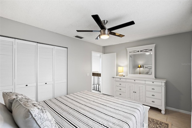 6140 Sun Blvd Unit 7, Saint Petersburg, FL 33715 - bedroom with a closet, a textured ceiling, a ceiling fan, and light tile patterned floors