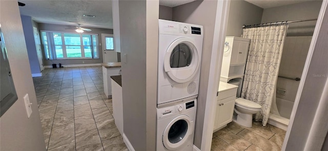 5725 80th St N Unit 107, Saint Petersburg, FL 33709 - laundry area featuring stacked washer / dryer, a ceiling fan, and light marble finish flooring