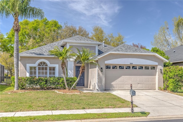 view of front of home featuring stucco siding, a front lawn, driveway, roof with shingles, and a garage