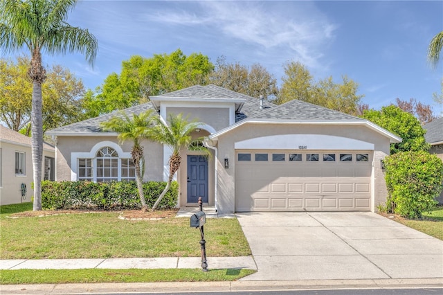 ranch-style home with a shingled roof, concrete driveway, a front yard, stucco siding, and a garage