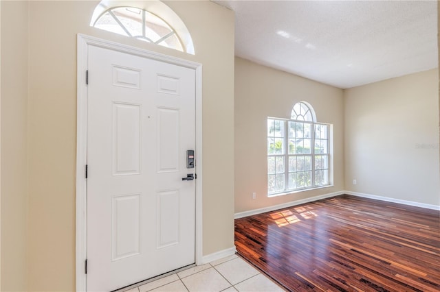 entrance foyer featuring light tile patterned flooring and baseboards