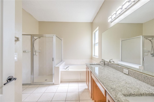 bathroom with tile patterned floors, a shower stall, a bath, and double vanity