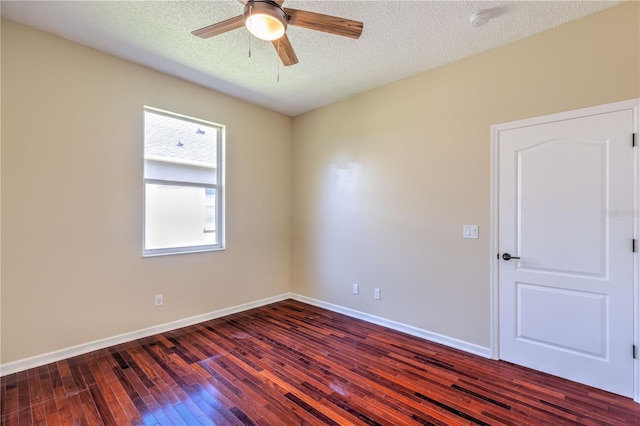 unfurnished room with dark wood finished floors, a textured ceiling, baseboards, and ceiling fan