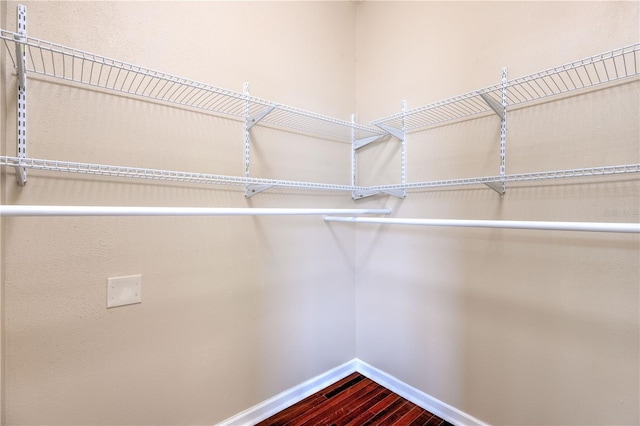 walk in closet featuring dark wood-style floors