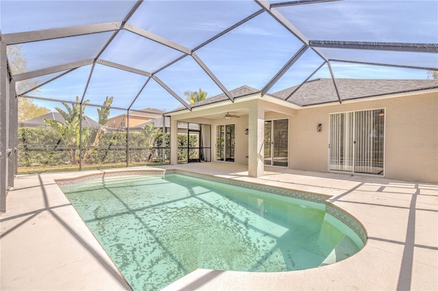 outdoor pool with a patio, a lanai, and a ceiling fan