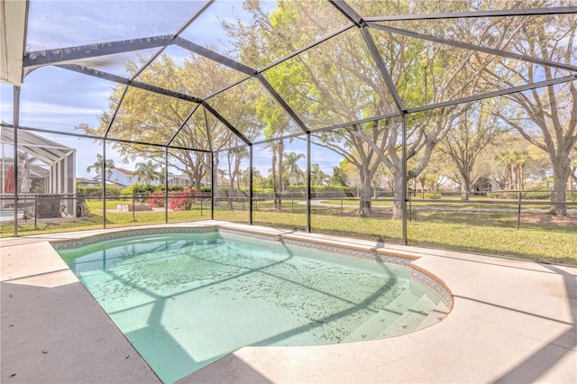 view of pool featuring glass enclosure, a patio, a lawn, and fence