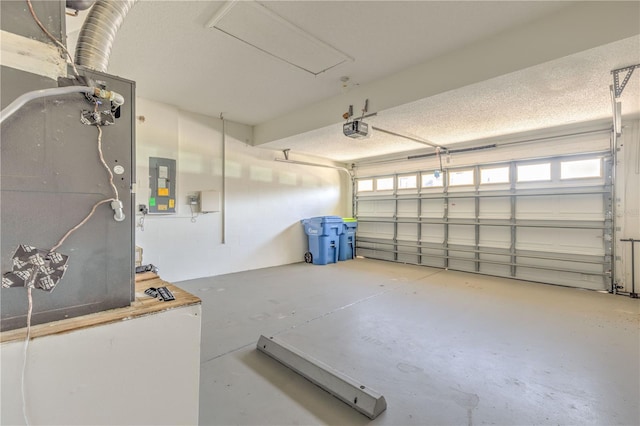 garage featuring electric panel and a garage door opener