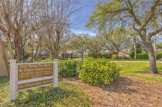 view of property's community with a lawn