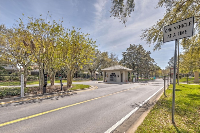 view of road featuring curbs and a gated entry