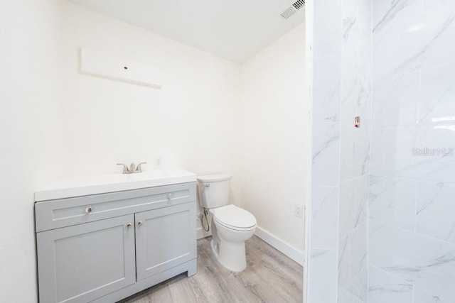 7322 Mako Dr, Hudson, FL 34667 - bathroom with visible vents, baseboards, toilet, wood finished floors, and vanity