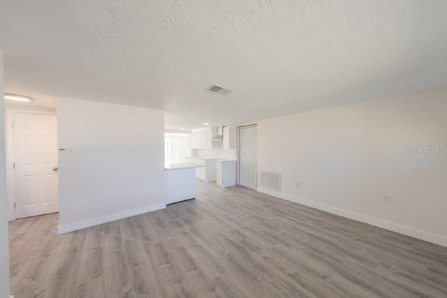 7322 Mako Dr, Hudson, FL 34667 - unfurnished living room featuring baseboards, light wood-style floors, and visible vents
