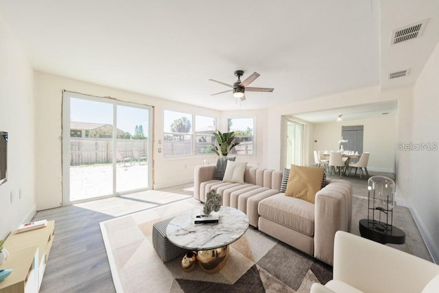 7322 Mako Dr, Hudson, FL 34667 - living room with a ceiling fan, wood finished floors, baseboards, and visible vents