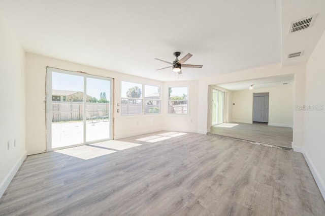 7322 Mako Dr, Hudson, FL 34667 - unfurnished living room featuring baseboards, visible vents, wood finished floors, and ceiling fan