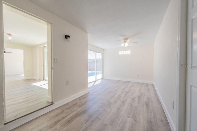 7322 Mako Dr, Hudson, FL 34667 - empty room with light wood-style flooring, baseboards, and ceiling fan
