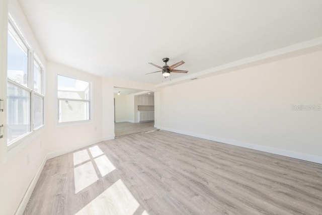 7322 Mako Dr, Hudson, FL 34667 - empty room featuring baseboards, light wood-style floors, and ceiling fan