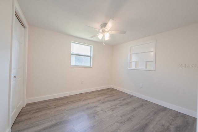 7322 Mako Dr, Hudson, FL 34667 - unfurnished bedroom with baseboards, a closet, wood finished floors, and ceiling fan