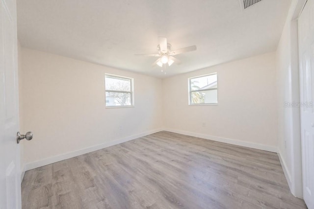 7322 Mako Dr, Hudson, FL 34667 - spare room featuring wood finished floors, plenty of natural light, baseboards, and ceiling fan