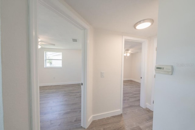 7322 Mako Dr, Hudson, FL 34667 - corridor with baseboards, visible vents, and wood finished floors