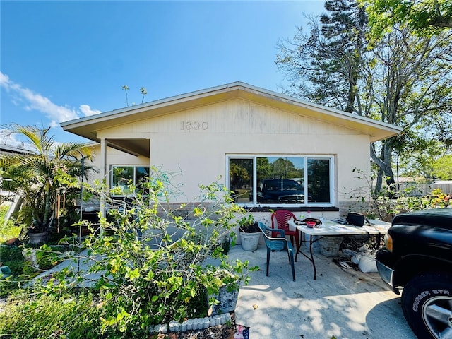 1800 New Hampshire Ave NE, Saint Petersburg, FL 33703 - rear view of property with stucco siding and a patio