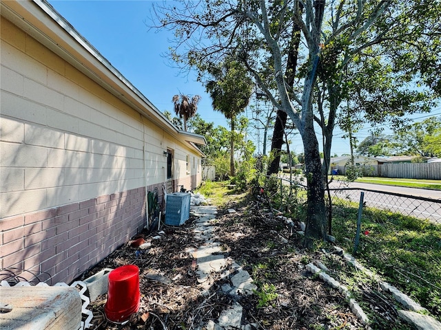 1800 New Hampshire Ave NE, Saint Petersburg, FL 33703 - view of home's exterior featuring central air condition unit, fence, and crawl space