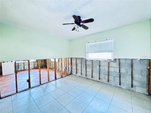1800 New Hampshire Ave NE, Saint Petersburg, FL 33703 - tiled empty room with a textured ceiling and ceiling fan