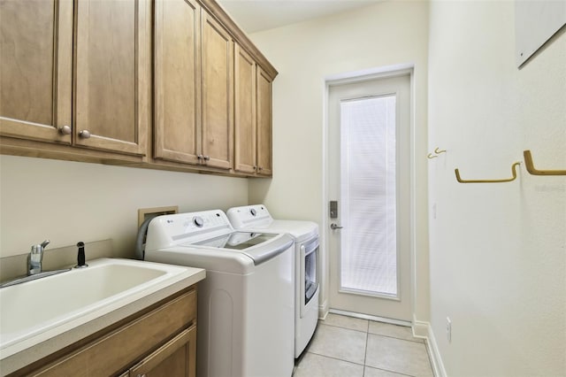 601 Viento De Avila, Tampa, FL 33613 - laundry area featuring baseboards, a sink, light tile patterned flooring, cabinet space, and washing machine and dryer