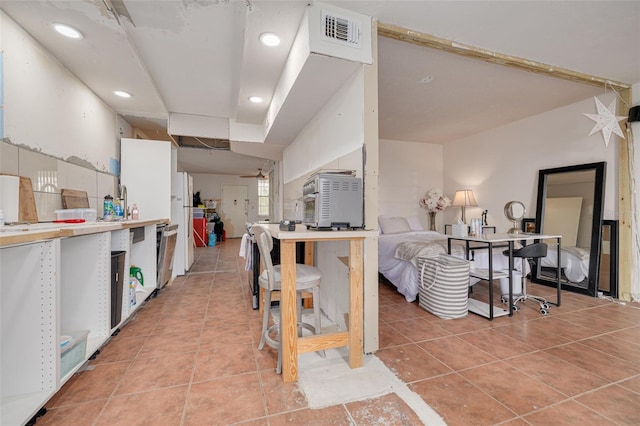 4885 1st St NE Unit 305, Saint Petersburg, FL 33703 - kitchen featuring visible vents, recessed lighting, white cabinets, light countertops, and light tile patterned floors