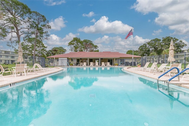 4885 1st St NE Unit 305, Saint Petersburg, FL 33703 - community pool featuring a patio and fence