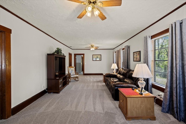 living area with light colored carpet, ornamental molding, a ceiling fan, and a textured ceiling