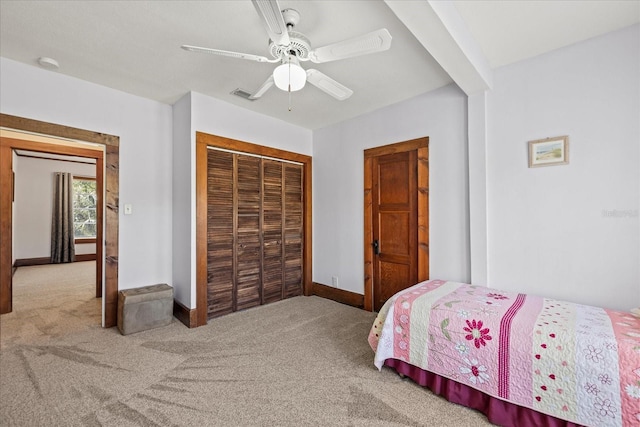 carpeted bedroom featuring visible vents, baseboards, a closet, and a ceiling fan