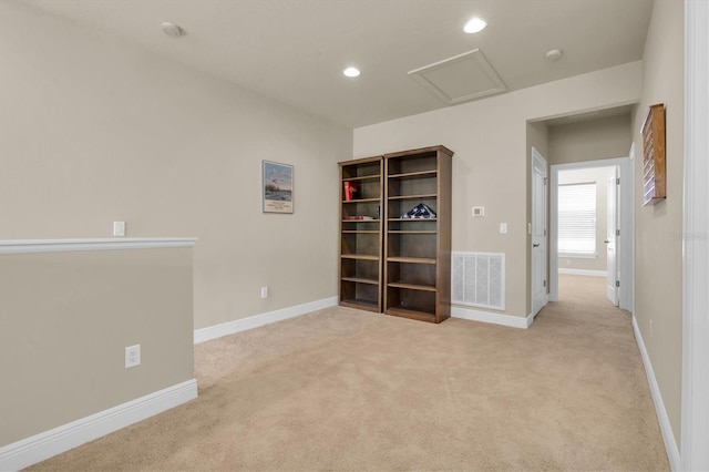 carpeted spare room with recessed lighting, visible vents, baseboards, and attic access