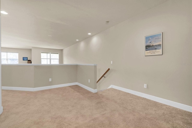 carpeted spare room featuring recessed lighting and baseboards