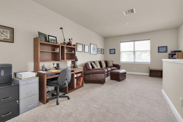 office space featuring visible vents, baseboards, and light colored carpet