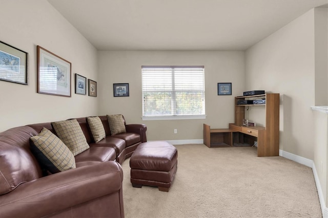 carpeted living room featuring baseboards