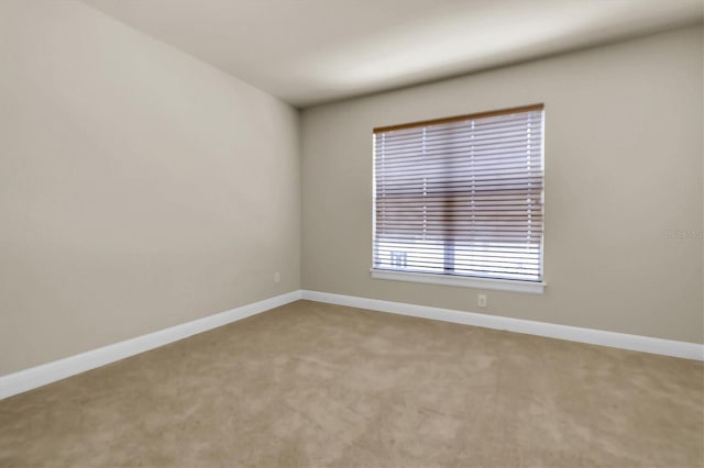 unfurnished room with baseboards and carpet floors